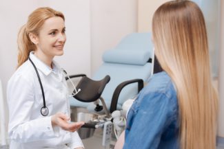 womens care nurse practitioner talking to patient